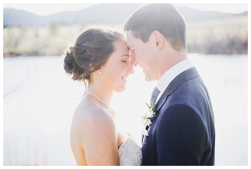 Portrait of bride and groom overlooking lake at Spruce Mountain Ranch