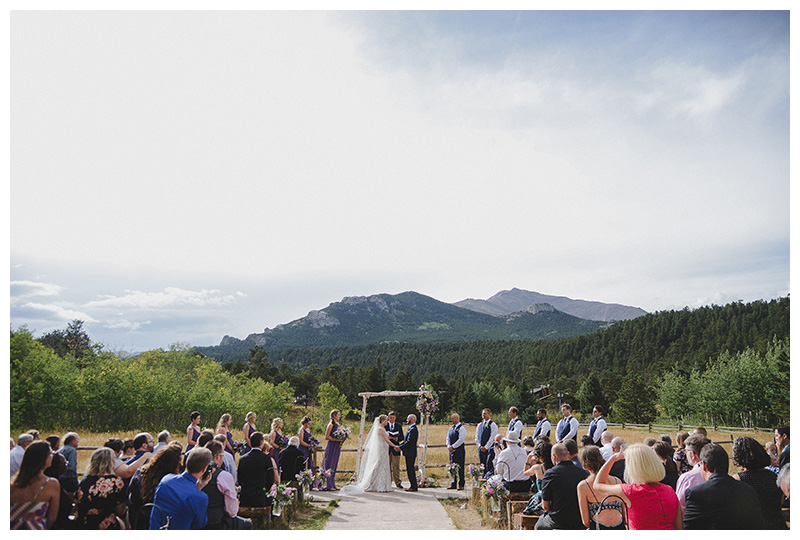 Wedding ceremony at Wild Basin Lodge, Colorado overlooking the forest